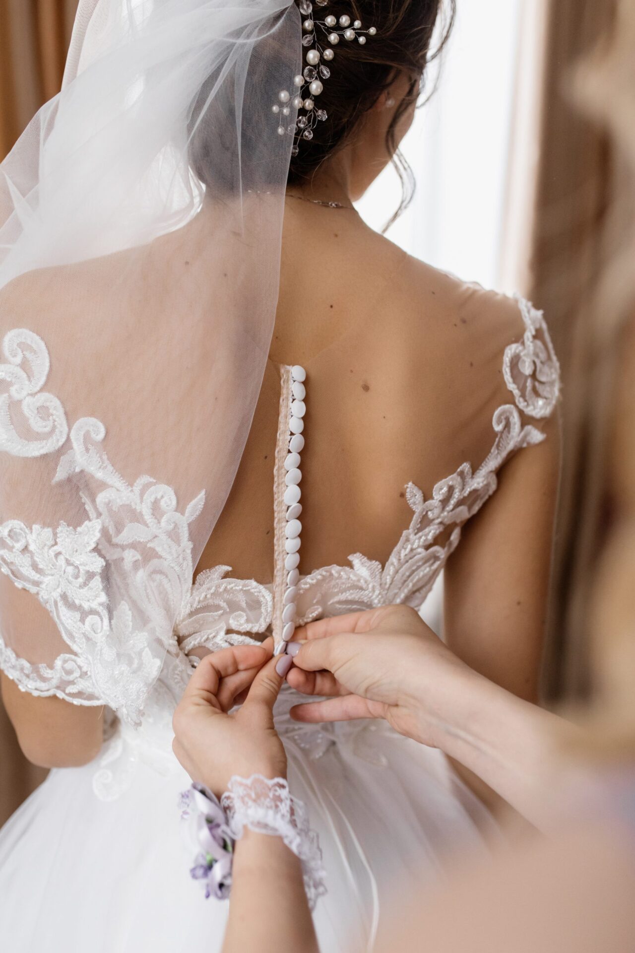 Bridal fitting with wedding dress button closure detail